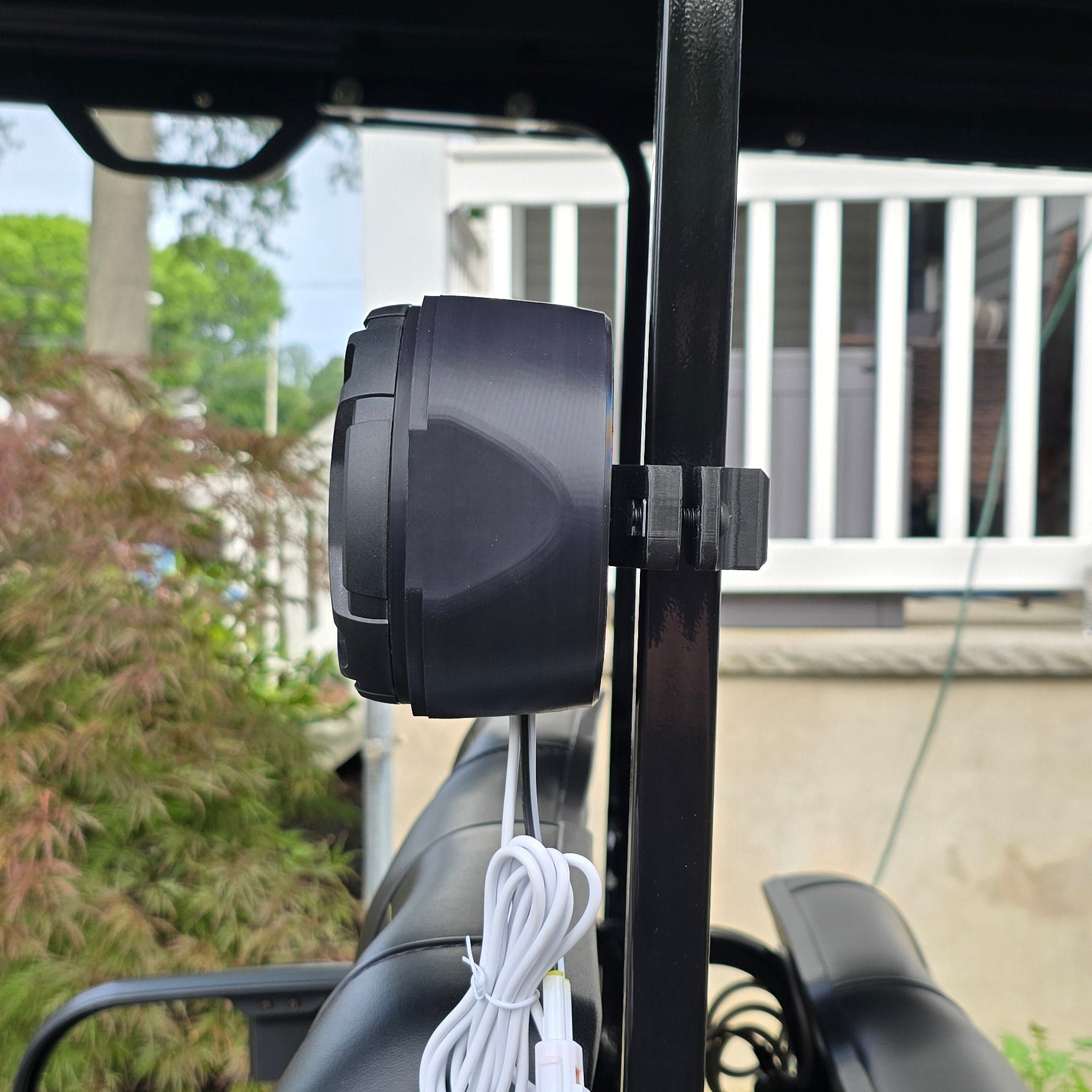 Speaker attached to a vehicle with a building in the background